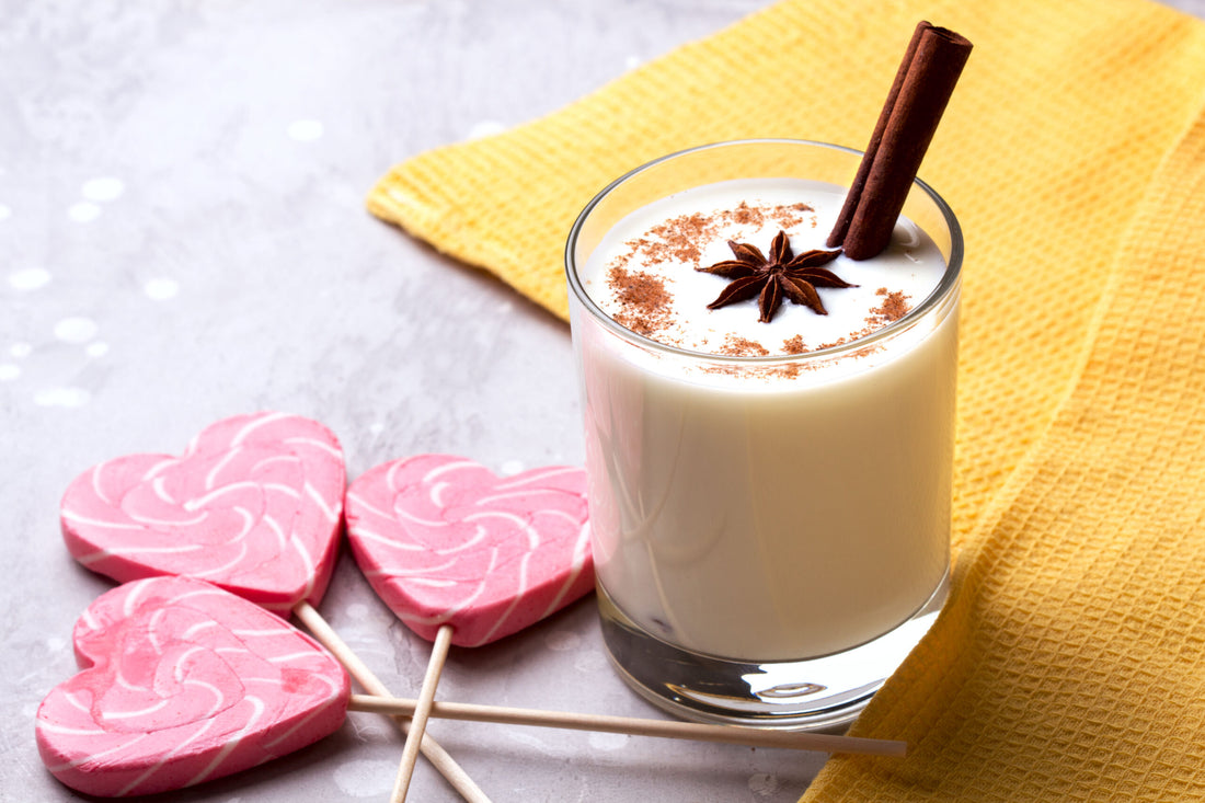 Glass of eggnog and candy cane.